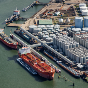 Aerial view of oil tankers moored at an oil storage silo terminal port